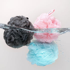 EcoTools EcoPouf 4-Pack Bath Sponge Set displayed on a bathroom shelf