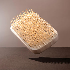 EcoTools Travel Detangler Hairbrush demonstrating heat resistance during blow drying