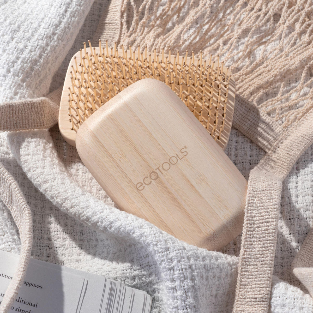 EcoTools Travel Detangler Hairbrush on a bathroom counter