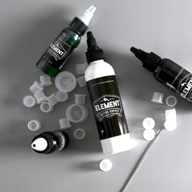 Element Tattoo Supply White Tattoo Ink 4oz bottle on a tattoo artist's table