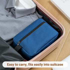 Elviros Travel Toiletry Bag Navy Blue next to travel essentials