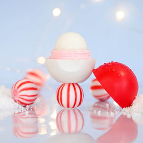eos lip balm Candy Cane Swirl with festive background