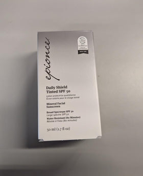 Epionce Daily Shield Tinted SPF 50 on a vanity with makeup