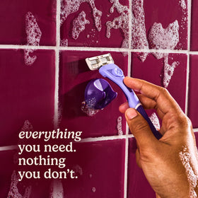 Ergonomic purple wavy grip handle of the razor