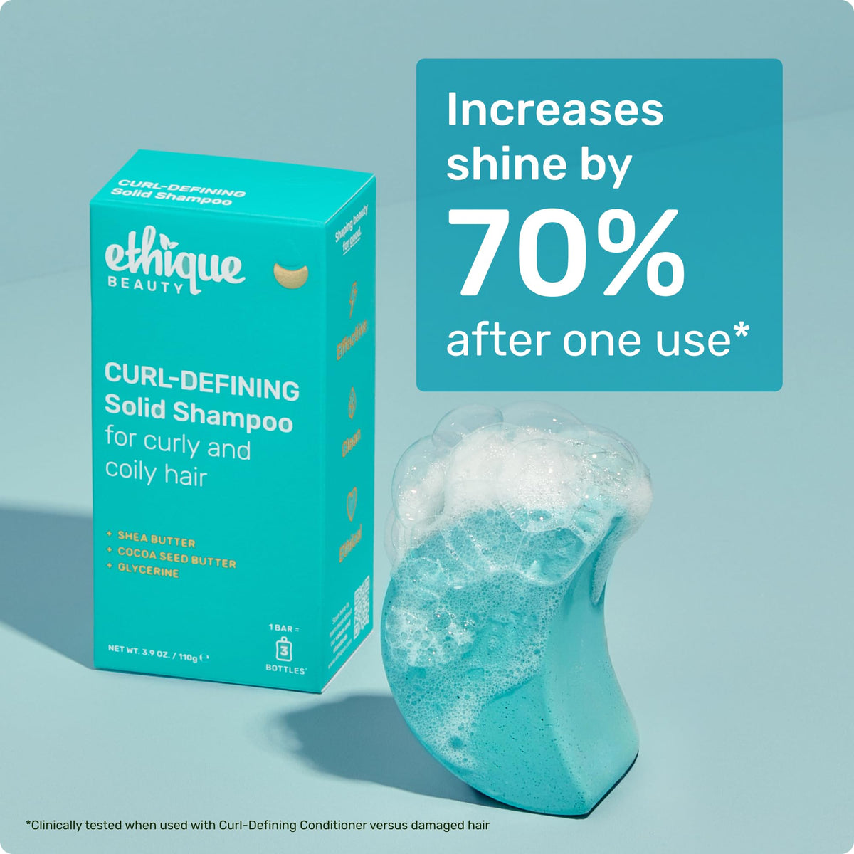 Ethique Curl-Defining Shampoo Bar next to travel essentials