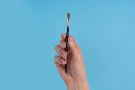 Existing Beauty Henna Eyebrow Brush on a makeup vanity