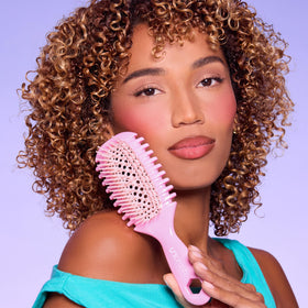 FHI Heat UNbrush Curl Detangling Brush on a styling table