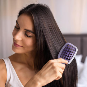 FHI Heat UNbrush Mini Detangling Brush on a bathroom counter