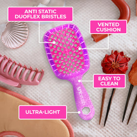 FHI Heat UNbrush Mini Detangling Brush on a travel bag