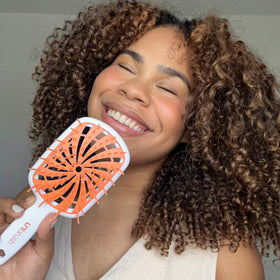 FHI Heat UNbrush Plus in use on curly hair