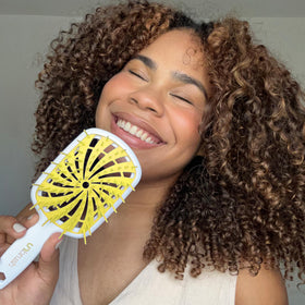 FHI Heat UNbrush Plus in use on wet curly hair