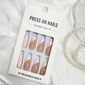 FJSMTOPl Almond Press on Nails displayed on a table