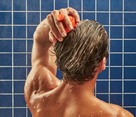 Flakes Anti Dandruff Shampoo being applied in the shower