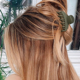 Flat lay of DEEKA Hair Claw Clips in stylish arrangement