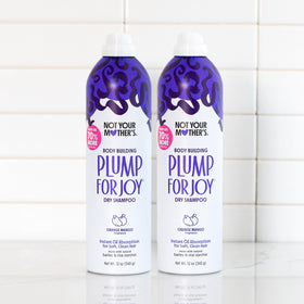 Flat lay of Not Your Mother's Jumbo Dry Shampoo with accessories