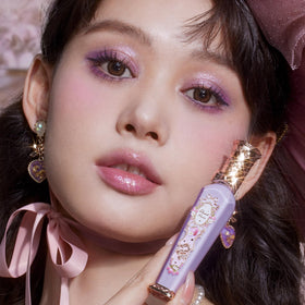 Flower Knows Rococo Glowy Lip Gloss lifestyle shot with flowers