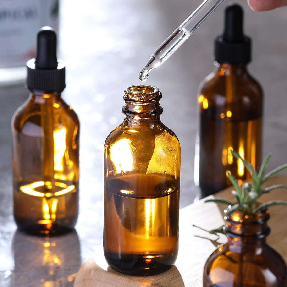 Four AOZITA dark amber glass bottles with labels