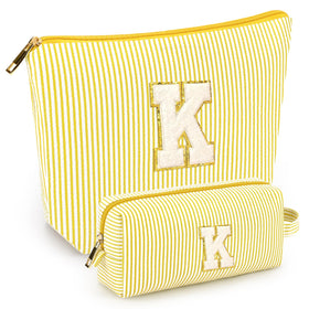 Front view of mibasies yellow cosmetic bag with letters