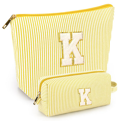 Front view of mibasies yellow cosmetic bag with letters