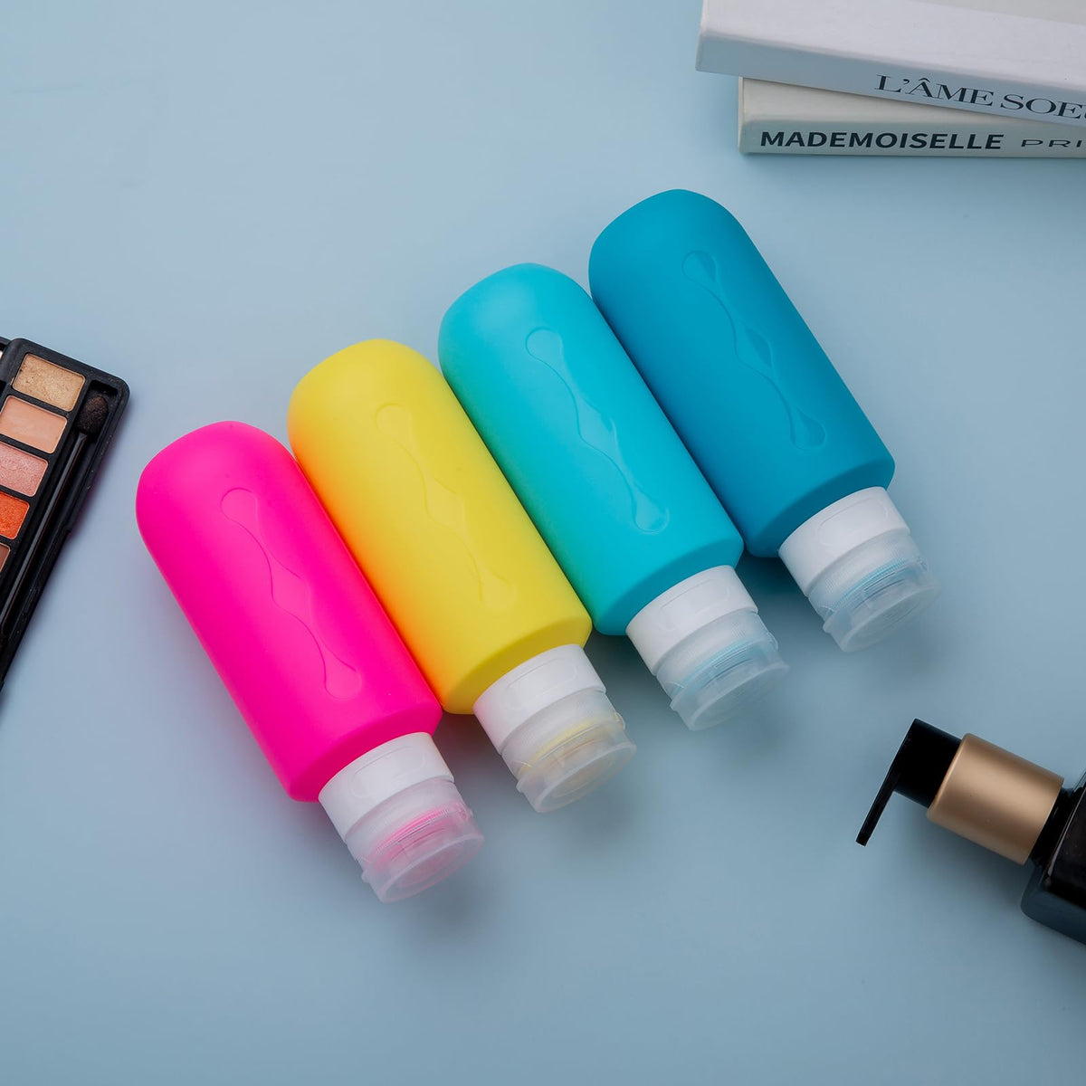 Gemice travel bottles displayed with travel accessories
