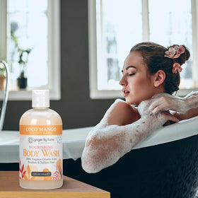 Ginger Lily Farms Coconut Mango Body Wash on a shower shelf