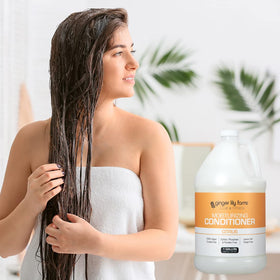 Ginger Lily Farms conditioner being applied to hair