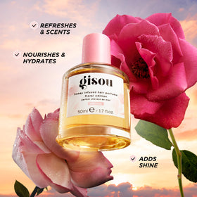 Gisou Honey Infused Hair Perfume Wild Rose bottle with floral background