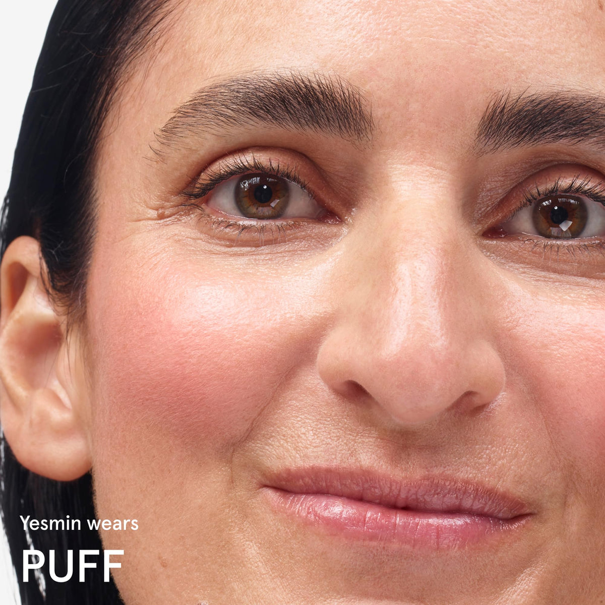 Glossier Cloud Paint Cream Blush Puff on model's cheeks