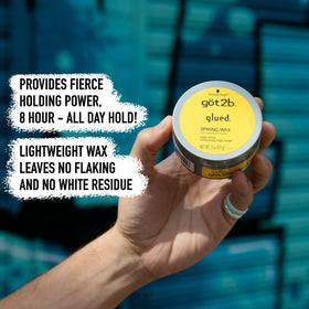 Got2B Glued Spiking Hair Wax on a vanity with styling tools