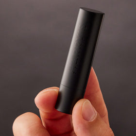 Harry's Black Lip Balm displayed with men's grooming products