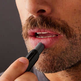 Harry's Black Lip Balm showing clear finish on lips