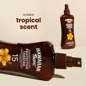 Hawaiian Tropic Tanning Oil Spray application on skin