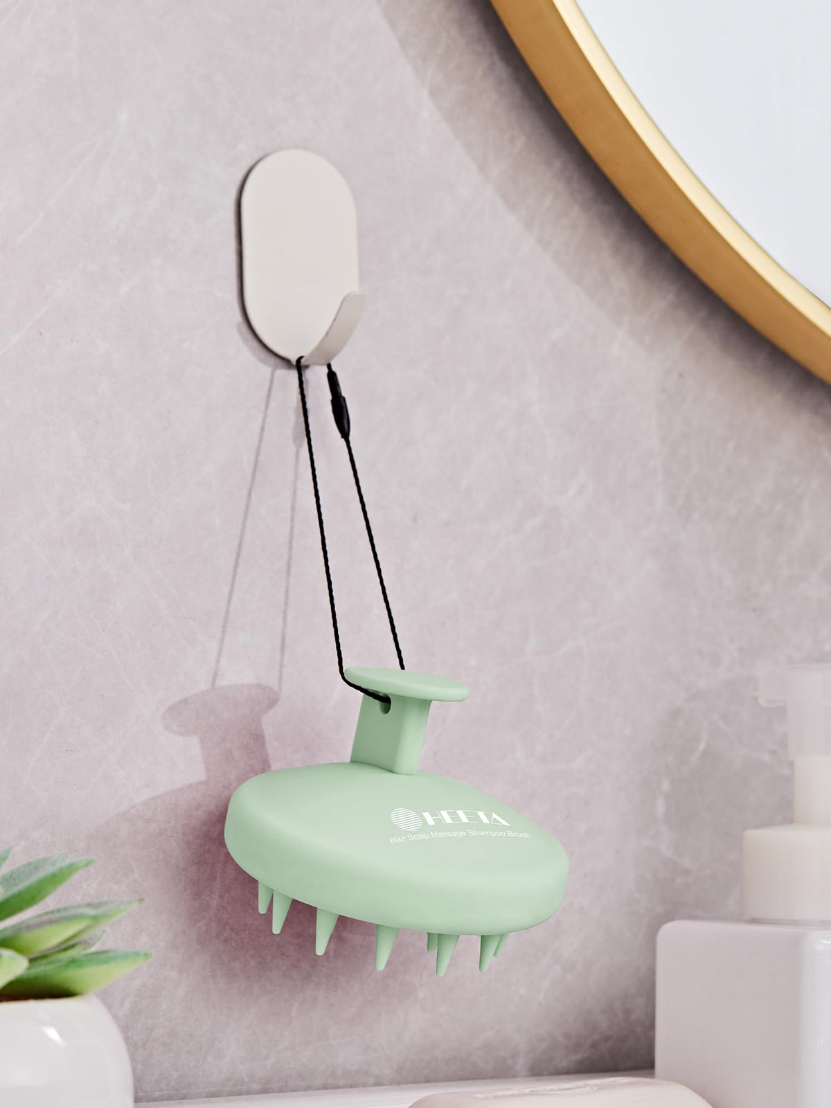 HEETA Silicone Scalp Massager in a hand for scale