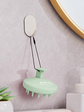 HEETA Silicone Scalp Massager in a hand for scale