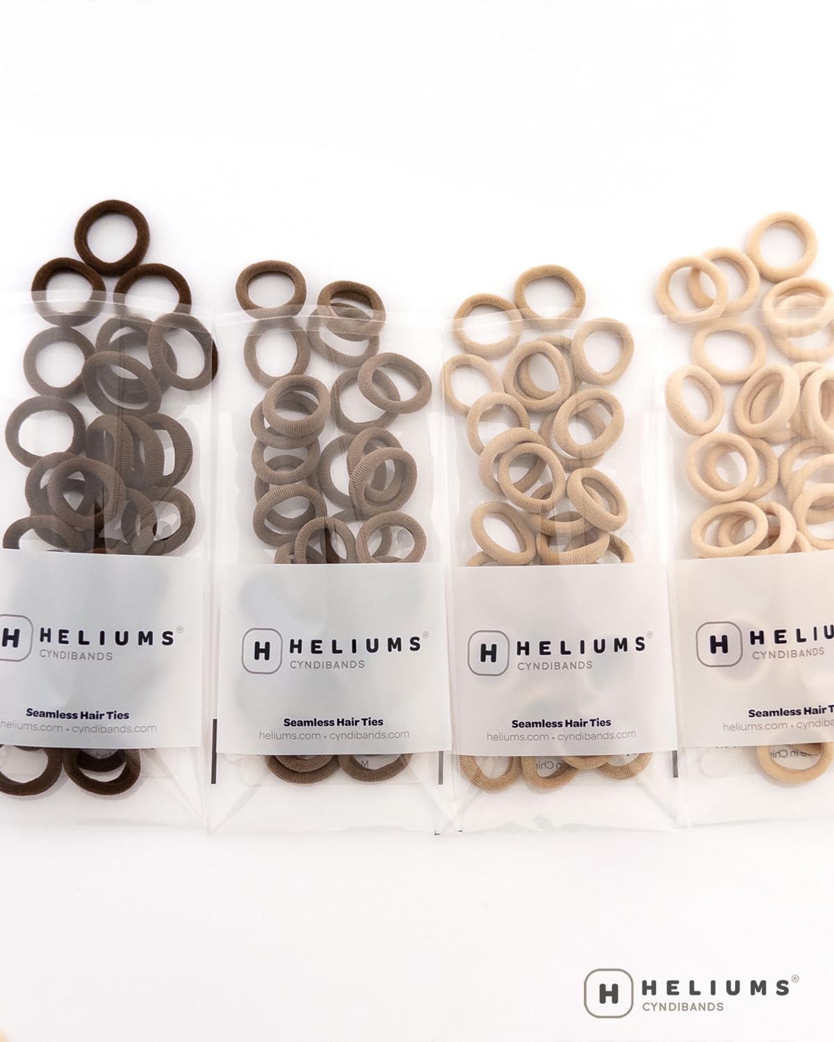 Heliums Extra Small Hair Ties showing size comparison with a coin