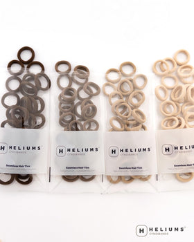 Heliums Extra Small Hair Ties showing size comparison with a coin