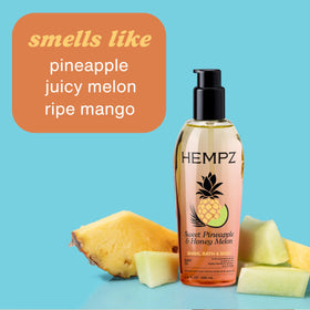 Hempz body oil in a lifestyle setting with tropical fruits