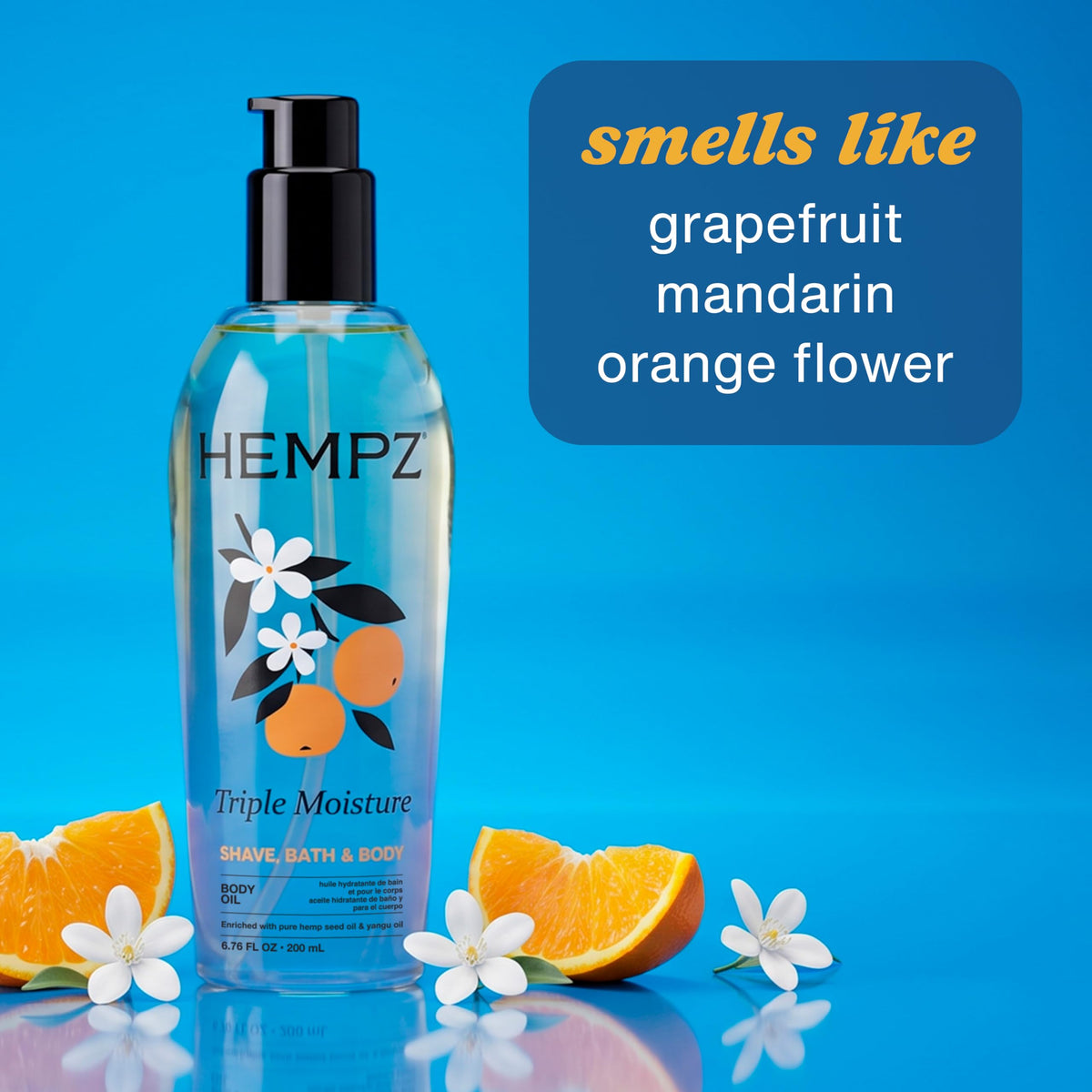 Hempz body oil with fresh citrus fruits in background
