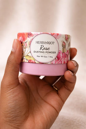 Herb & Root Rose Dusting Powder with floral background