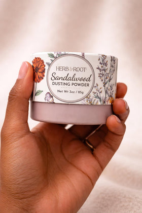 Herb & Root Sandalwood Dusting Powder 2 oz on a bathroom shelf
