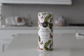 Herb & Root Vanilla Body Dusting Powder with fresh flowers
