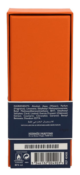 Hermès Eau De Citron Noir bottle on a vanity with accessories
