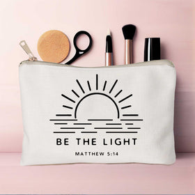 HubbgDesign Be The Light makeup bag with scripture on display