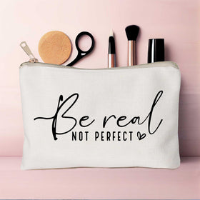 HubbgDesign makeup bag alongside makeup products on table
