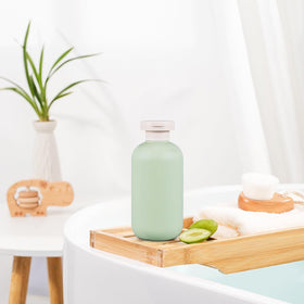 Inverted UMETASS travel shampoo bottle showing smooth extrusion