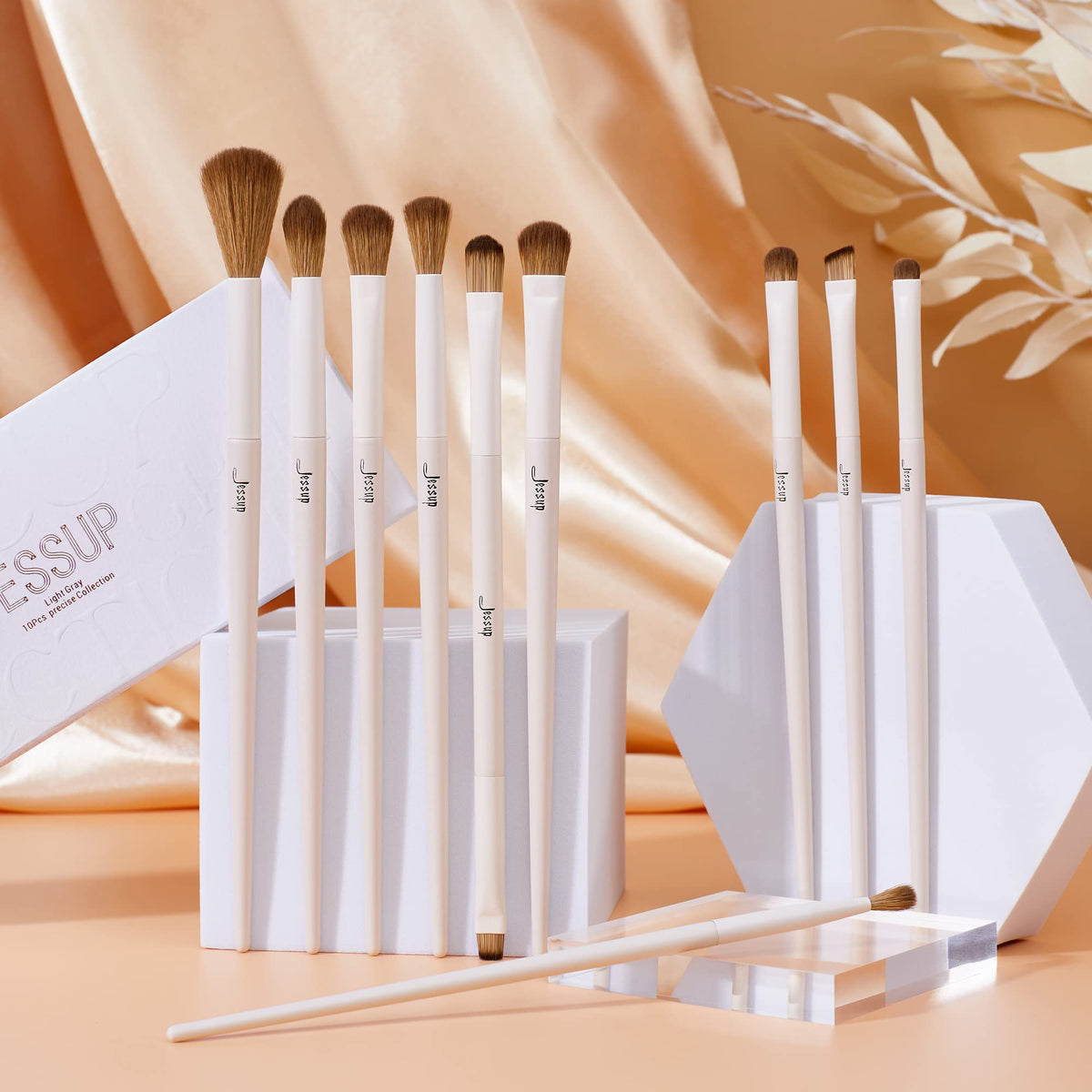 Jessup eye makeup brushes displayed with makeup products