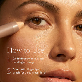 Josie Maran Argan Cream Concealer Crayon Dark 1 with makeup brush