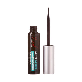 KISS Lash Couture adhesive black formula on a makeup table