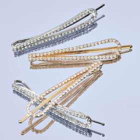 Kitsch bobby pins in gold and silver on a flat surface