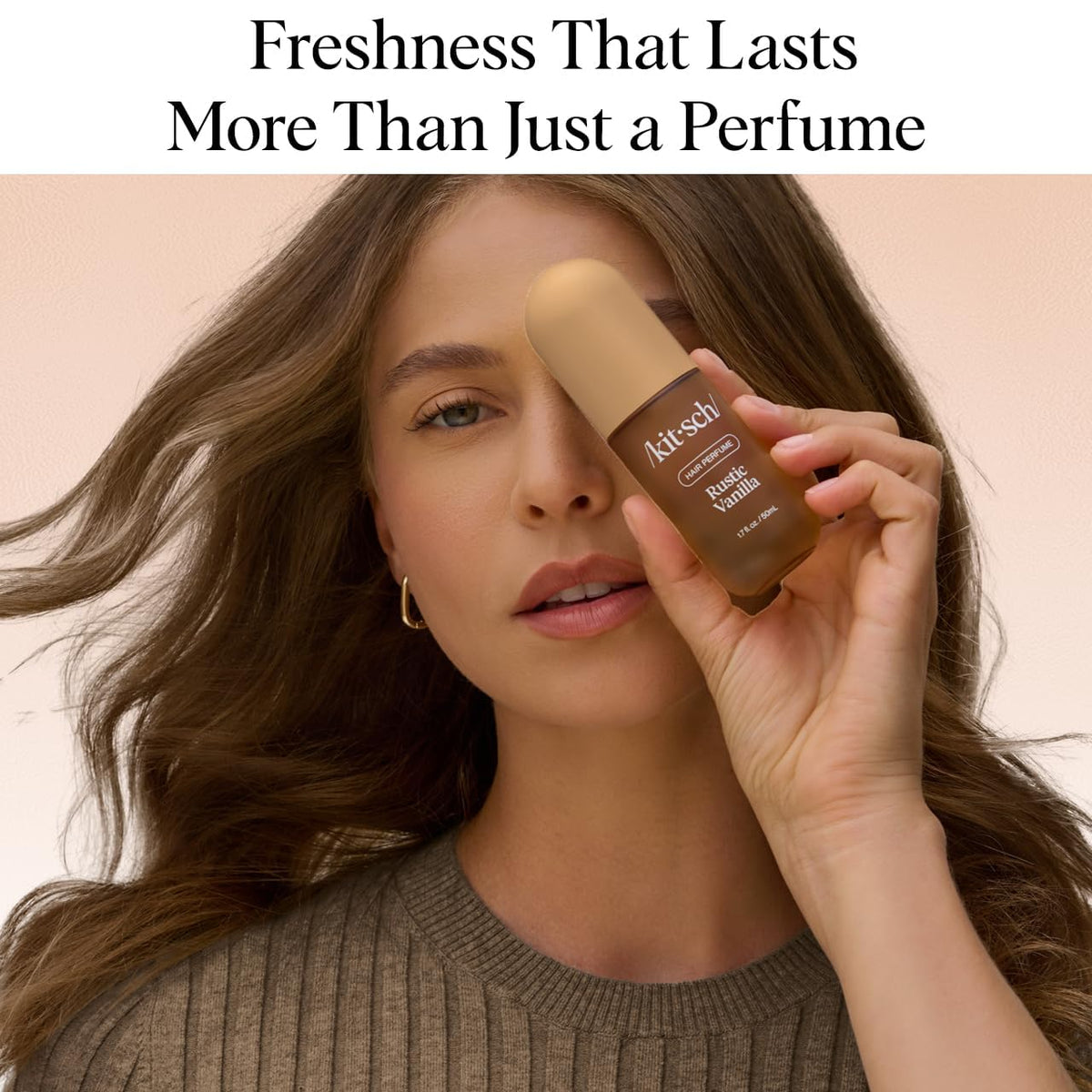 Kitsch Hair Perfume 50 mL bottle on a vanity with flowers